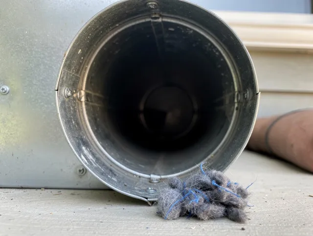 Kendale Lakes Dryer Vent Cleaning technician using specialized equipment to clear severe dryer vent blockage in Kendale Lakes